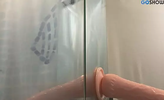 Woman enjoys big dildo under shower, wet and wild licking experience